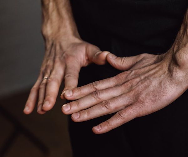 Close-up of hands in a yoga mudra gesture.
